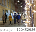 People walking on a street with beautiful Christmas decorations at night, in the city center of Graz, Styria region, Austria. Selective focus 120452986
