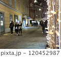 People walking on a street with beautiful Christmas decorations at night, in the city center of Graz, Styria region, Austria. Selective focus 120452987
