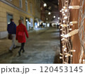 People walking on a street with beautiful Christmas decorations at night, in the city center of Graz, Styria region, Austria. Selective focus 120453145