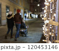 Family walking on a street with beautiful Christmas decorations at night, in the city center of Graz, Styria region, Austria. Selective focus 120453146