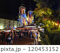 People at a Christmas market with beautiful lights decorations and Mariahilfer church , at night, in the city center of Graz, Styria region, Austria 120453152