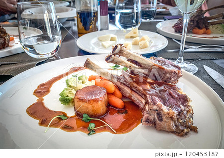 Main dish lamb, tape, broccoli carrot boy on white plate 120453187