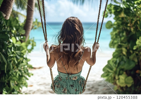 Tourist enjoying freedom swinging on tropical beach paradise 120455388