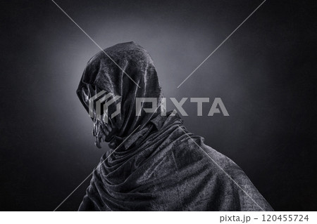 Creepy figure with animal skull at night over dark misty background Creepy figure with animal skull at night over dark misty background 120455724