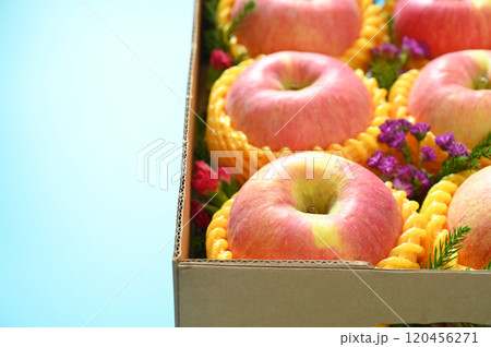beautiful pink apple in the box on blue background 120456271