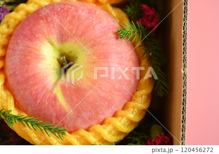 beautiful apple in the box on pink background, healthy fruit 120456272