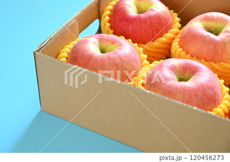 beautiful pink apple in the box on blue background 120456273