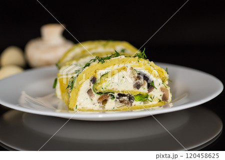 baked potato roll with cottage cheese filling with garlic and mushrooms, isolated on black background baked potato roll with cottage cheese filling with garlic and mushrooms, isolated on black background 120458625
