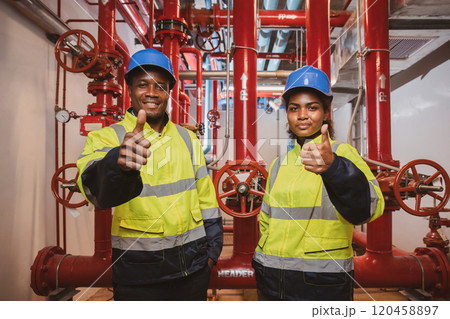 Engineer or technician work checking Fire suppression system and fire equipment. Engineer check red generator pump for water sprinkler piping and fire alarm control system 120458897