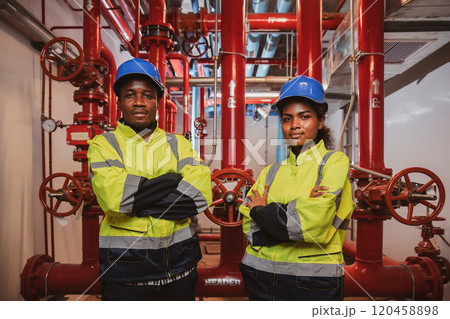 Engineer or technician work checking Fire suppression system and fire equipment. Engineer check red generator pump for water sprinkler piping and fire alarm control system 120458898