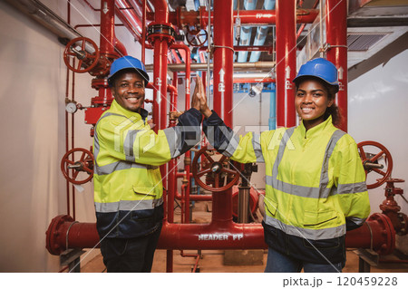 Electrical engineer team are working in control room. Electrical engineer man checking Power Distribution Cabinet in the control room Electrical engineer team are working in control room. Electrical engineer man checking Power Distribution Cabinet in the control room 120459228