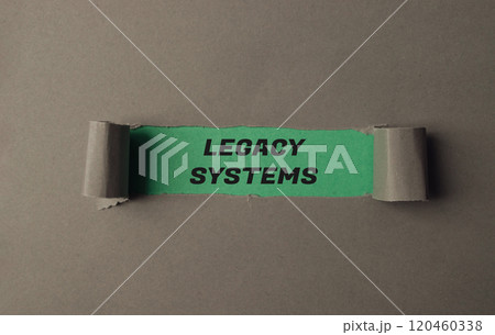 A torn piece of paper with the word Legacy Systems written on it A torn piece of paper with the word Legacy Systems written on it 120460338