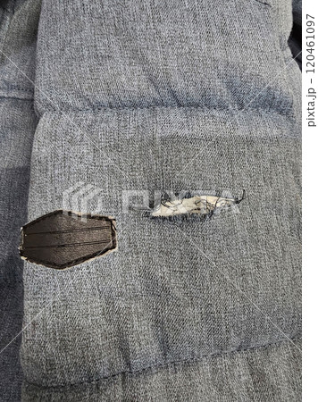 Blue fabric ripped at the sleeve. 120461097