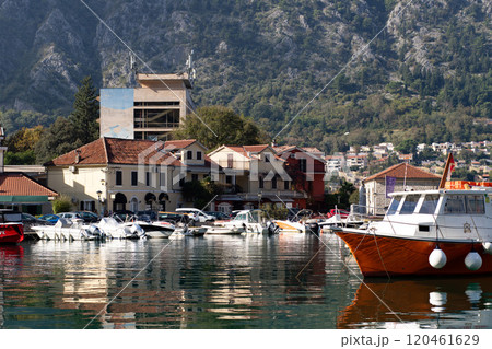 View of Kotor buildings from the bay, boats against the backdrop of buildings. View of Kotor buildings from the bay, boats against the backdrop of buildings. 120461629