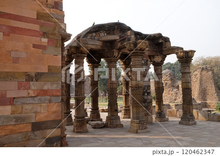 Columns with stone carving in courtyard of Quwwat-Ul-Islam mosque, Qutub Minar complex, Delhi, India Columns with stone carving in courtyard of Quwwat-Ul-Islam mosque, Qutub Minar complex, Delhi, India 120462347