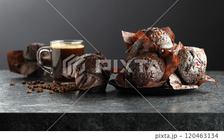 Dark chocolate muffins and cup of black coffee. Dark chocolate muffins and cup of black coffee. 120463134