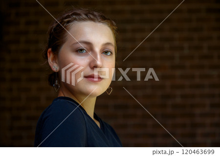 Elegant Young Woman in Black Dress with Makeup and Earrings Elegant Young Woman in Black Dress with Makeup and Earrings 120463699