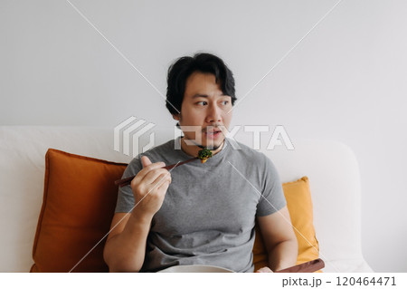 Man eating his homemade diet meal in the pan as it is his daily routine. Man eating his homemade diet meal in the pan as it is his daily routine. 120464471