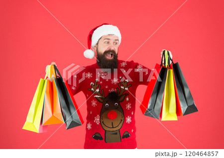 Santa is coming. Bearded hipster carry shopping bags. Packages with gifts. Happy man bought gifts. Spending more than you planned initially. Shopaholic concept. Christmas gifts. Presents for family Santa is coming. Bearded hipster carry shopping bags. Packages with gifts. Happy man bought gifts. Spending more than you planned initially. Shopaholic concept. Christmas gifts. Presents for family 120464857