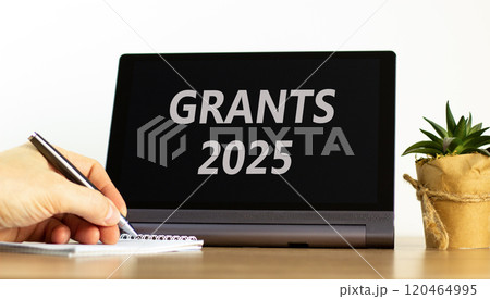 Planning grants 2025 new year symbol. Concept words Grants 2025 on beautiful black tablet. Beautiful white background. Businessman hand. Business grants 2025 new year concept. Copy space. 120464995