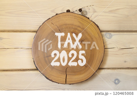 Planning tax 2025 new year symbol. Concept words Tax 2025 on beautiful wooden circle. Beautiful wooden wall background. Business tax 2025 new year concept. Copy space. 120465008