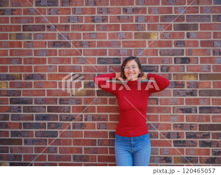Woman in glasses stands in center of Frankfurt, 120465057