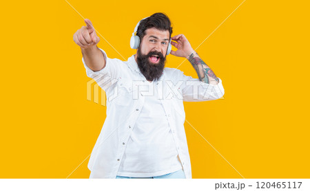 dj man wearing music headphones pointing finger in studio. man listen music in dj headphones. 120465117