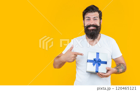 bearded man go shopping for birthday, point finger. man in studio with birthday gift. shopping bearded man go shopping for birthday, point finger. man in studio with birthday gift. shopping 120465121