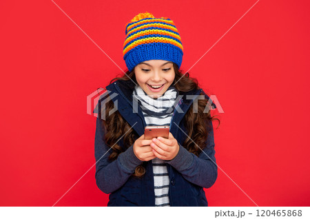 portrait of child blogging with phone. express positive emotion. greeting with winter holidays. 120465868
