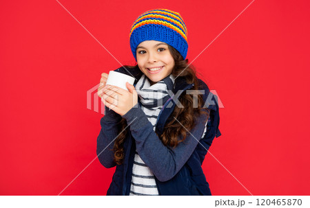 drinking cocoa and milk. smiling kid in puffer waistcoat and hat. teen girl drink warm tea 120465870