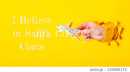 Toy airplane is being held up by a person 120466153