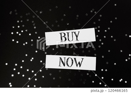 Buy now is written on a black background with stars 120466165