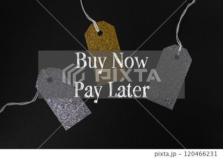 Three tags with gold and silver glitter hanging from a string 120466231