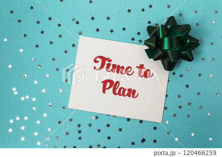 White card with red writing that says Time to Plan is sitting on a blue back White card with red writing that says Time to Plan is sitting on a blue back 120466259