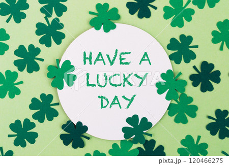 A green and white circle with four green clovers surrounding it A green and white circle with four green clovers surrounding it 120466275