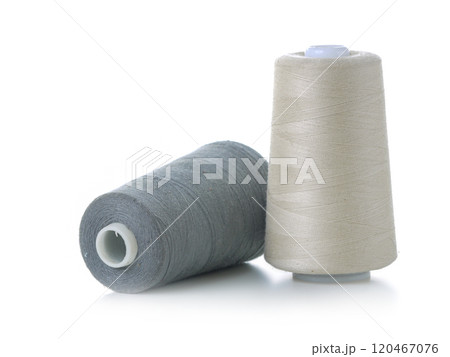 Close-Up of Two Thread Spools in White and Gray Close-Up of Two Thread Spools in White and Gray 120467076