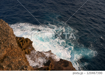 Cinematic aerial landscape shots of the beautiful island of Nusa Penida. Huge cliffs by the shoreline and hidden dream beaches with clear water and foaming wave. 120467390