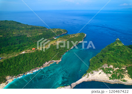 Cinematic aerial landscape shots of the beautiful island Diamond beach of Nusa Penida. Huge cliffs by the shoreline and hidden dream beaches with clear water. 120467422