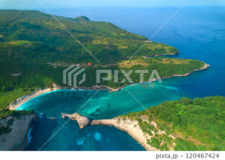 Cinematic aerial landscape shots of the beautiful island Diamond beach of Nusa Penida. Huge cliffs by the shoreline and hidden dream beaches with clear water. 120467424