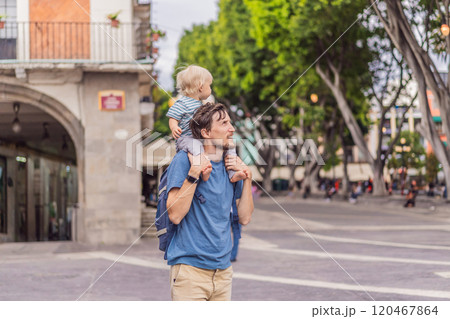 Father tourist with his toddler son walking through the colorful colonial streets of Puebla, Mexico. Travel, cultural exploration, and vibrant architecture concept Father tourist with his toddler son walking through the colorful colonial streets of Puebla, Mexico. Travel, cultural exploration, and vibrant architecture concept 120467864