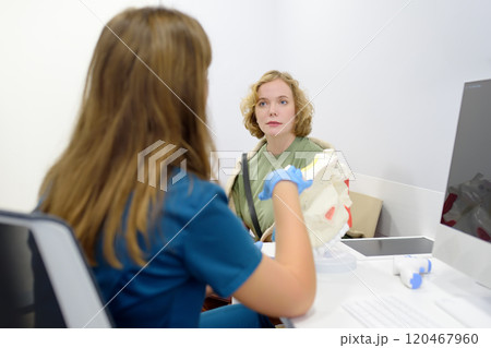 The otolaryngologist explains to the patient about his illness at the appointment. A professional ENT doctor demonstrates a model of the human nose. Treatment of inflammation disease of nose. The otolaryngologist explains to the patient about his illness at the appointment. A professional ENT doctor demonstrates a model of the human nose. Treatment of inflammation disease of nose. 120467960