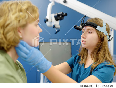 A professional ENT doctor examines a patient 120468356