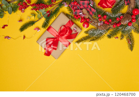 Christmas background, wrapped gift in brown paper and red silk ribbon, top view 120468700