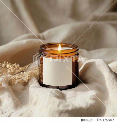 Boho amber glass jar candle mockup, white blank label design preview, beige and brown bohemian home interior with dried flowers and linen 120470507