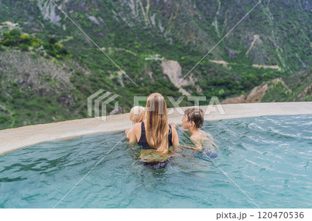Mother with her toddler and teenage sons bathing in the hot springs of Grutas Tolantongo, Mexico. Family adventure, relaxation, and natural wellness concept Mother with her toddler and teenage sons bathing in the hot springs of Grutas Tolantongo, Mexico. Family adventure, relaxation, and natural wellness concept 120470536