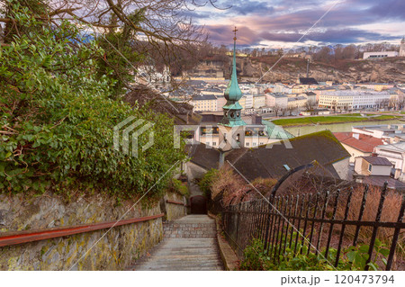 Steps of an old staircase and a church spire in Salzburg, Austria 120473794