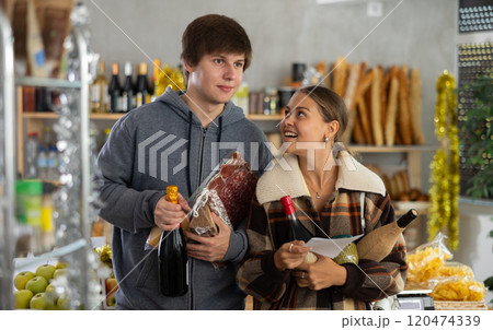 Couple man and woman choosing food from shopping list 120474339