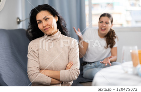 Young female couple quarreling at home Young female couple quarreling at home 120475072