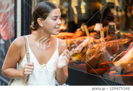 Young girl chooses delicacy - exquisite dry-aged beef on restaurant display 120475148
