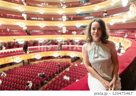 Adult woman posing on balcony at opera house Adult woman posing on balcony at opera house 120475467